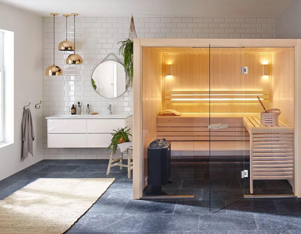 Helo Havanna 900D sauna heater on floor of small sauna with glass front situated in a bathroom with lovely natural light