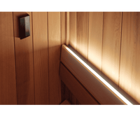 Western red cedar  panel with a light strip running along its edge in the corner of a sauna