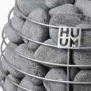 rounded grey stones enveloped by stainless steel frame of huum sauna heater