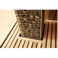 Close up of HUUM Cliff sauna heater embedded into wooden bench