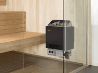 Helo Cup STJ sauna heater mounted on wall of small light wood sauna adjacent to a glass pane