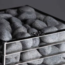Close up of  top of Huum Cliff Sauna  showing rocks enveloped in stainless steel