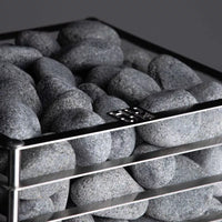 Close up of  top of Huum Cliff Sauna  showing rocks enveloped in stainless steel