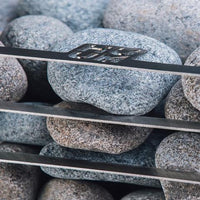 Huum Cliff Mini sauna heater close-up of sauna rocks against the stainless steel construction