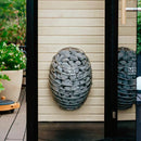 HUUM Drop sauna heater in light filled outdoor setting
