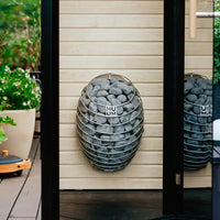 HUUM Drop sauna heater in light filled outdoor setting