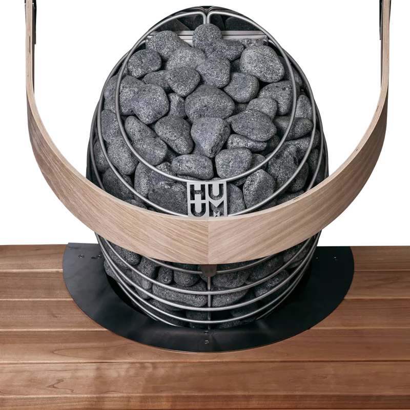 Huum drop sauna heater embedded in sauna bench showing safety rail and flange in situ