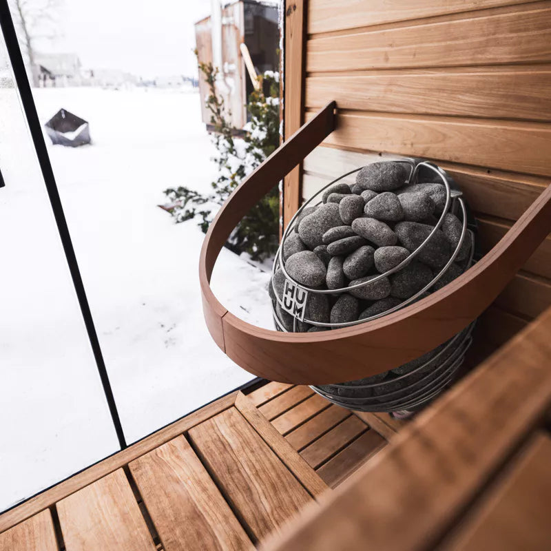 HUUM Drop sauna heater in light filled sauna with snowy background vista