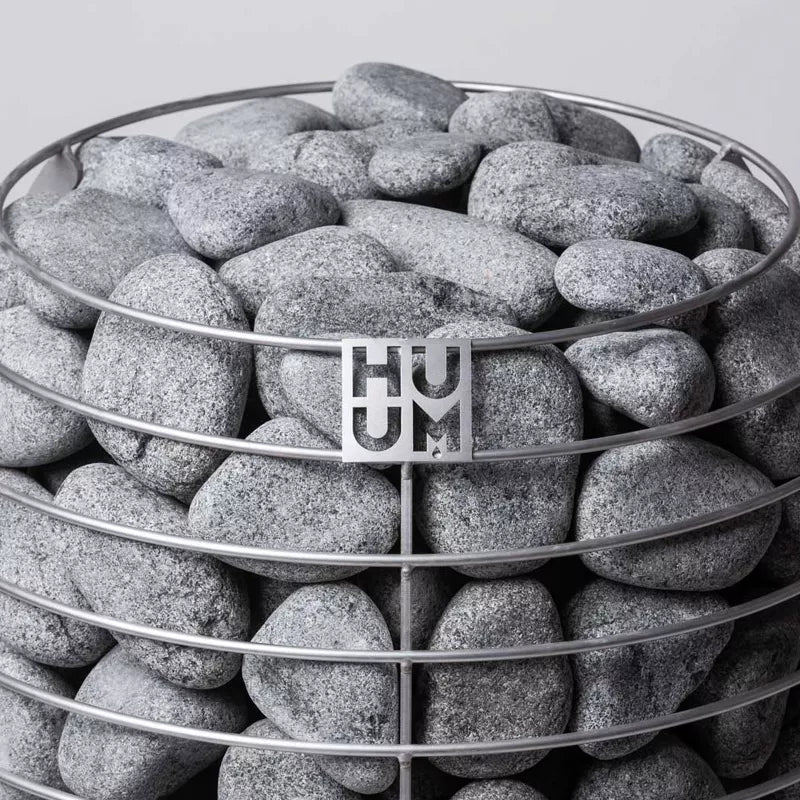 Close-up of top half of Huum Hive sauna heater showing rocks and the steel frame