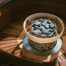 Huum Hive mini sauna heater with safety rail and embedding flange showered in natural light