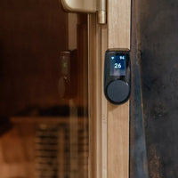Huum black uku local control fixed on outside of sauna on a wooden panel
