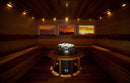 Interior of a sauna with embedded Iki Pillar sauna heater with scenic window views.