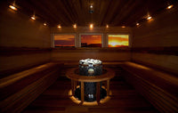 Interior of a sauna with embedded Iki Pillar sauna heater with scenic window views.