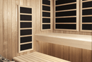 Wooden sauna interior with four black infrared panels on the walls